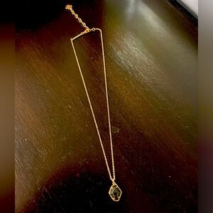 Stunning rose gold necklace with black stone pendant.